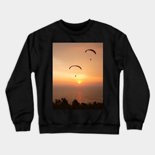 Paragliding over the ocean and treetops while golden sunset Crewneck Sweatshirt